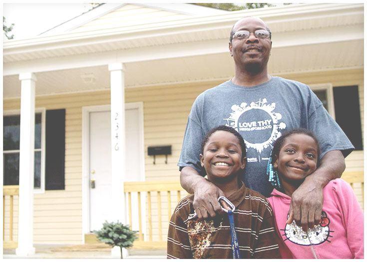 Family in front of Habitat for Humanity home