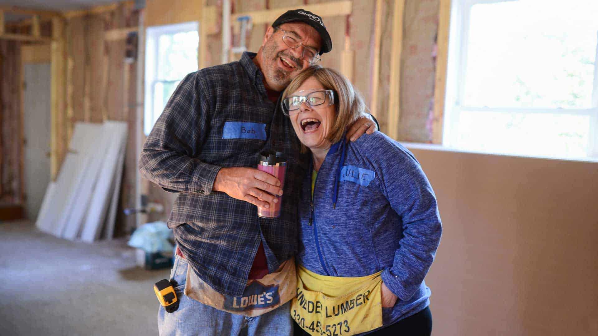 Habitat for Humanity homeowner holding keys to home.