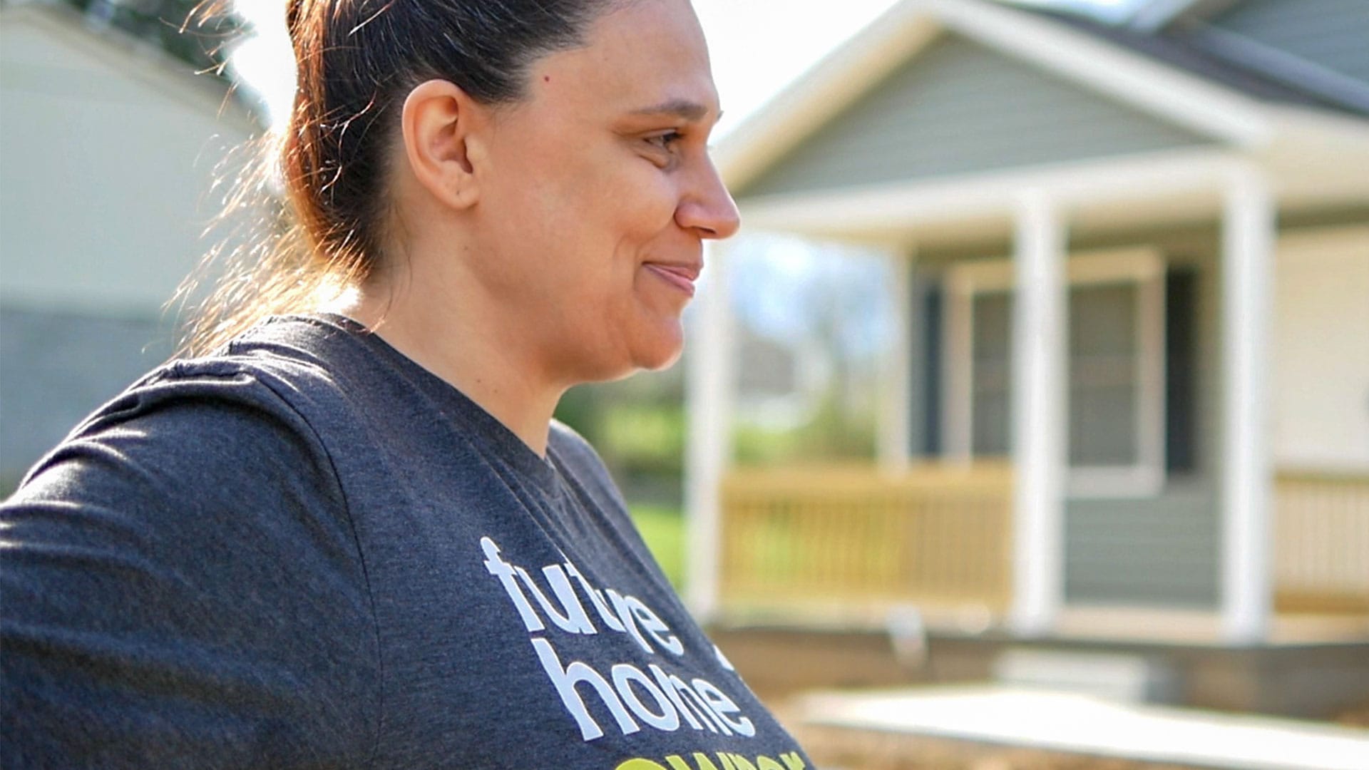 Habitat for Humanity homeowner holding keys to home.